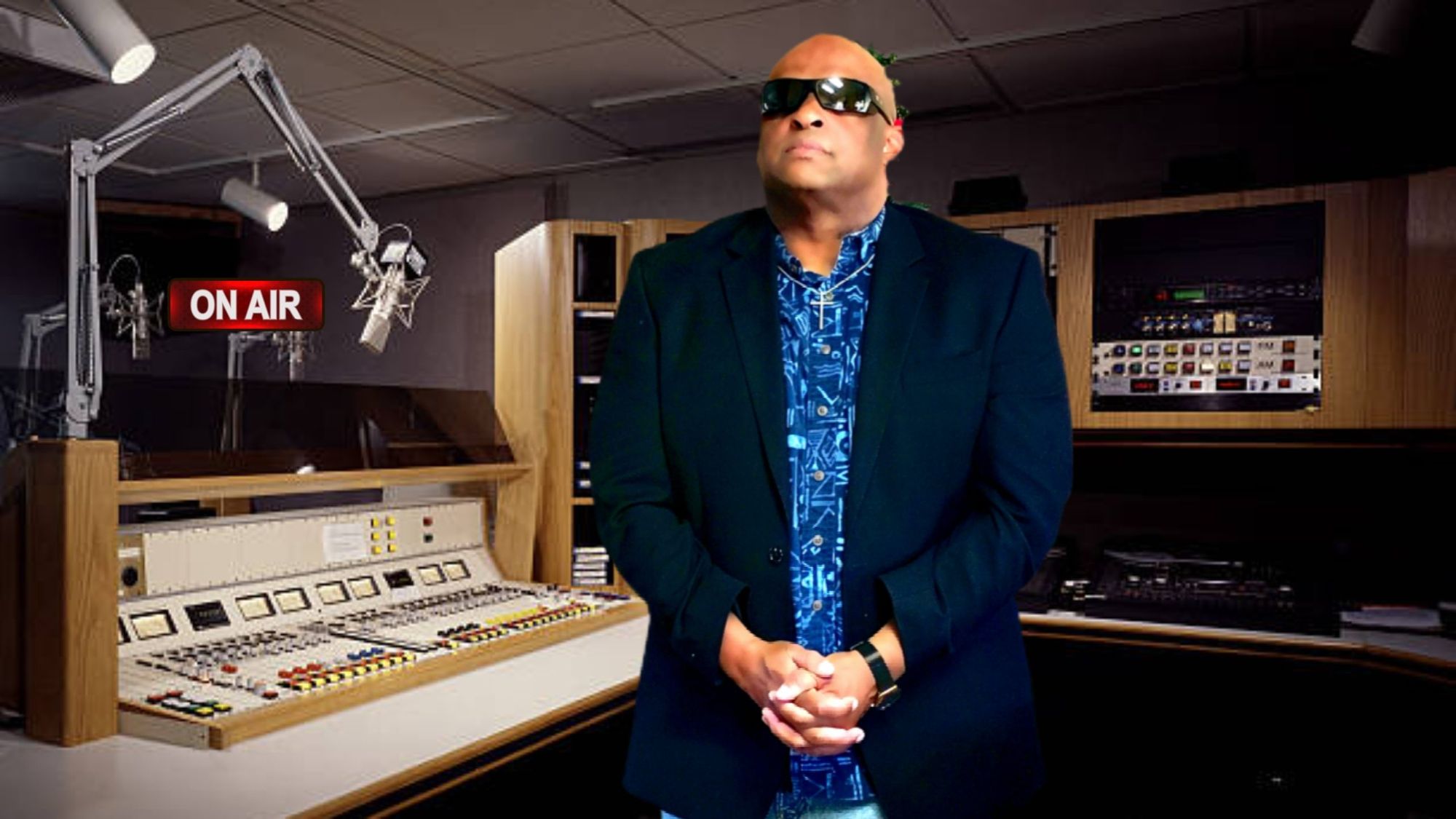 Vinn standing in a radio studio, with the ON AIR sign lit behind him